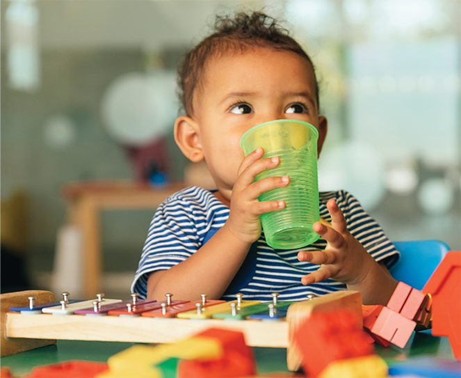 infant drinking safe clean healthy water in child care facility