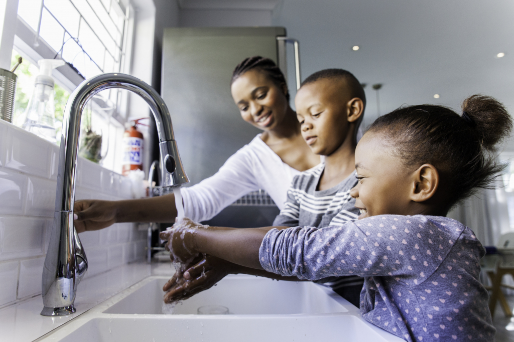 Mother and children washing hands