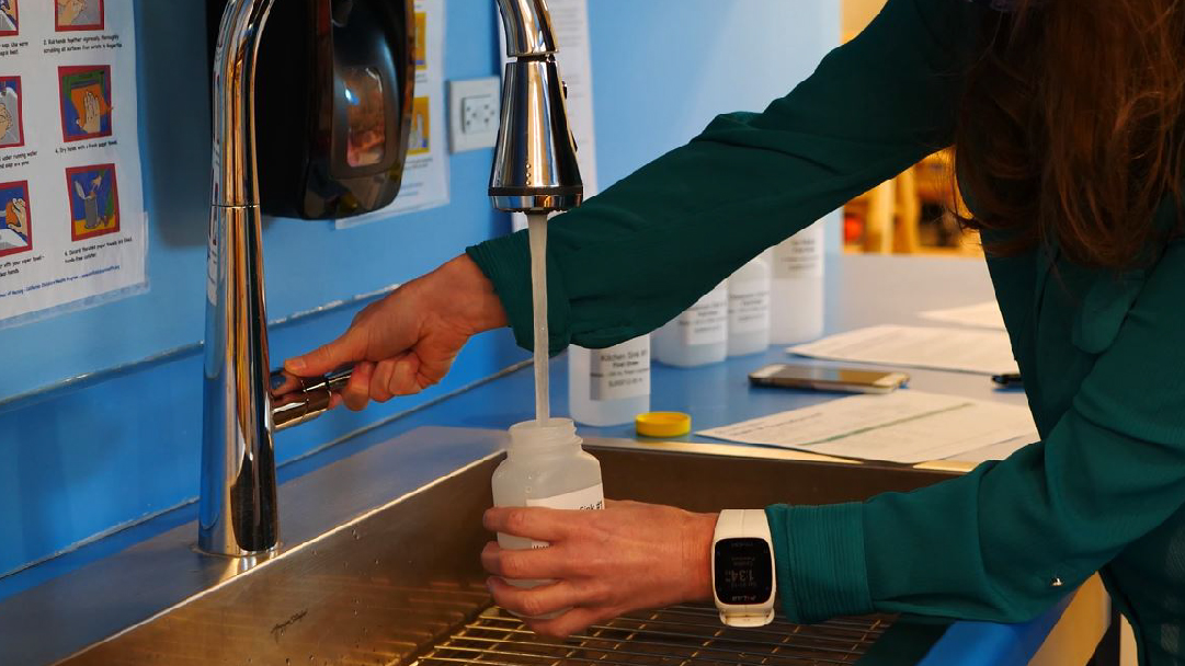 Collecting Tap Water For Testing Sample