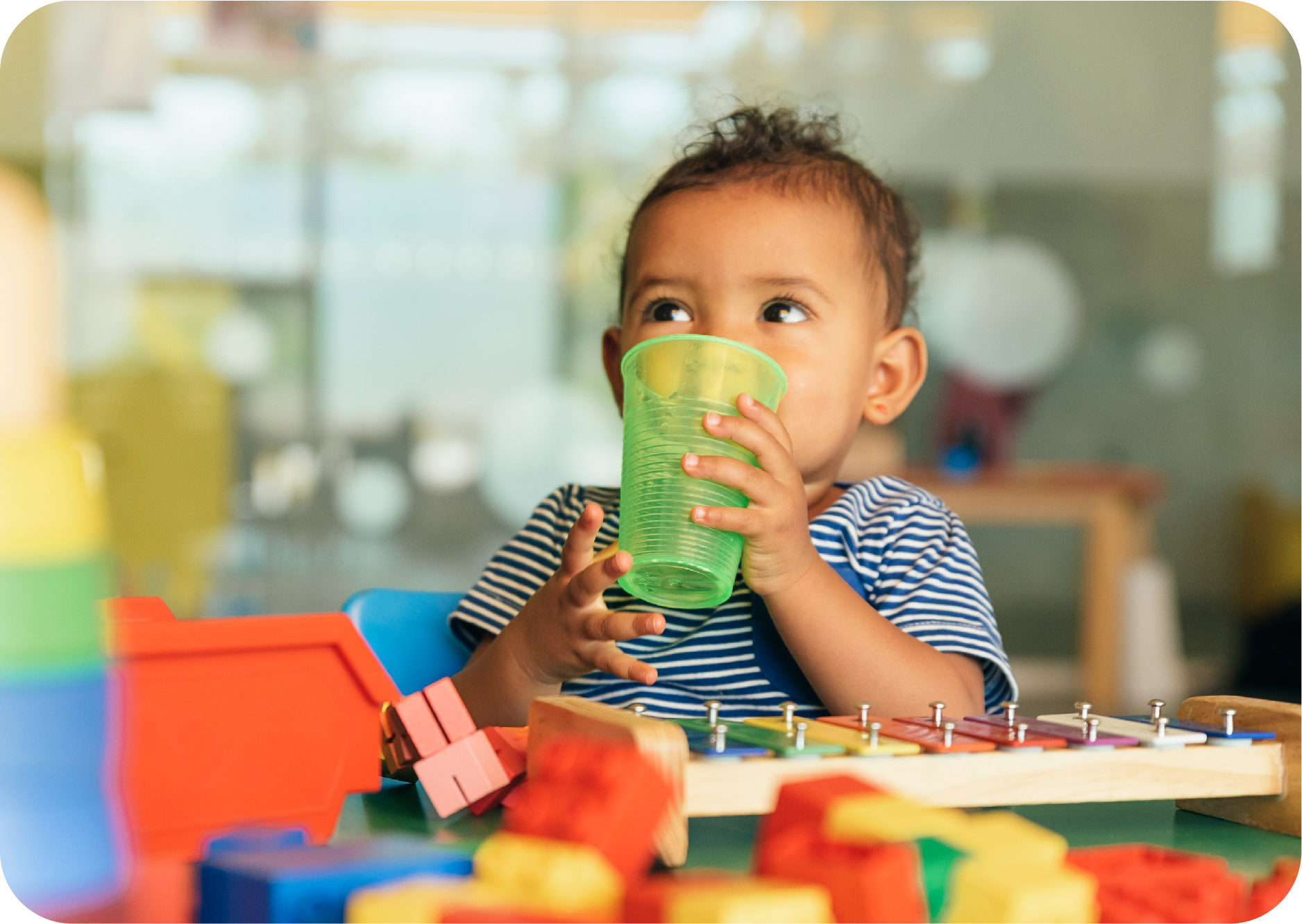 A child drinking from a cup at a home-based child care provider